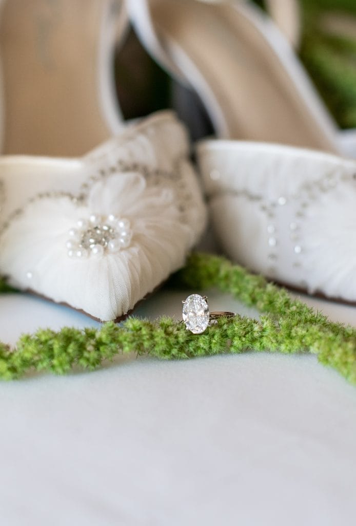 Bride's jeweled wedding shoes and wedding rings